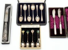 A set of six silver teaspoons, four silver and enamel teaspoons with emblems of the UK,