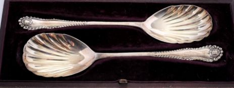 A pair of Edward VII silver serving spoons, makers mark worn, London, 1905: with shell shaped bowls,