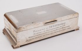An Elizabeth II silver presentation cigarette box, maker Adie Bros, Birmingham, 1955: inscribed,