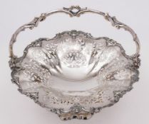 A plated circular swing-handled fruit basket: with pierced and scroll decoration,