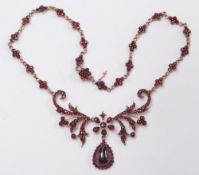 A Bohemian garnet necklace: of open scroll work design,