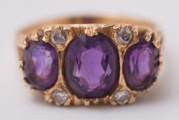 An 18ct gold, amethyst and diamond seven-stone ring: with graduated,