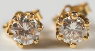 A pair of yellow gold and diamond single stone ear studs:, each with a circular,