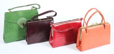 A green 'snake skin' hand bag together with various red, orange and purple hand bags:.