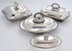 Four Edwardian silver plated entree dishes: of various shaped with lids and handles.