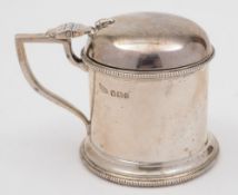 An Edward VII silver mustard pot, maker Walker and Hall, Sheffield, 1909:, of cylindrical outline,