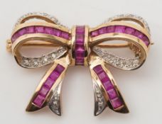 A calibre-cut ruby and diamond mounted 'bow' brooch:, approximately 27mm total length.