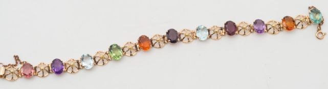 A multi-gem set bracelet stamped '18K' with eleven various coloured,