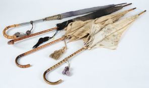 Four early 20th century silk parasols: with faux bamboo handles.