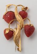 A coral mounted 'strawberry' spray brooch:, designed as a stem of four carved coral strawberries,