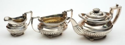 A George III antique silver three-piece oval tea set: with reeded lower bodies, gadroon edging,