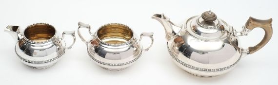 A plated three-piece tea service, by Elkington & Co: of squat circular form, with beaded girdle,