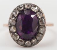 An Amethyst coloured paste & rose diamond oval cluster ring:.