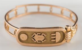 A broken gold Egyptian bangle with Hieroglyphics:, approximately 23gms gross weight.