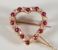 A gold, ruby and rose diamond mounted heart shaped brooch:.