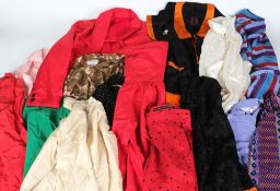 A large collection of various silk and cotton blouses, twin sets, skirts:, etc.