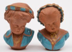 A pair of Watcombe (Torquay) pottery busts: of young children he with pointed cap and broad collar