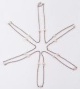 A platinum and seed pearl fine link chain: with seventeen seed pearls, approximately 3.