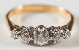 An 18ct gold, platinum and graduated diamond five stone ring:.