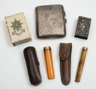 Two amber and gold mounted cheroot holders, silver cigarette cases and two matchbox holders:.