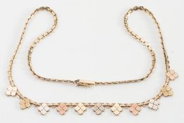 A yellow gold necklace: stamped '14K' with three colour gold motifs.