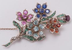 A multi coloured gem-set, floral spray brooch: approximately 85mm long, 27gms gross weight.