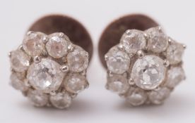 A pair of diamond circular floral cluster ear studs: each with a central circular,