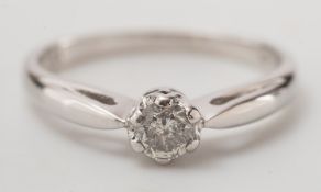 A 9ct white gold and diamond single stone ring:, the circular,
