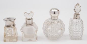 Four clear glass and silver mounted scent bottles: various makers and dates.