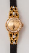 A lady's 18ct gold and diamond mounted 'Omega' wristwatch in case with papers:.