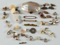 A pair of gold and circular moonstone cuff-links ( some damage ), together with an oval shell purse,