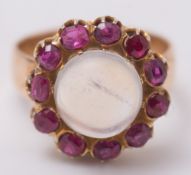 A moonstone and ruby cluster ring:,