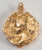 An early 20th century French gold locket with diamond chips:.