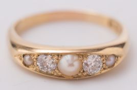An 18ct gold, pearl and diamond ring: in elliptical setting.
