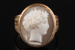 An oval shell cameo portrait mounted ring:, the reverse with glazed compartment, ring size R.