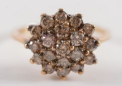 A 9ct gold and diamond circular cluster ring: with circular, brilliant cut stones.