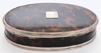 A small Edwardian tortoiseshell and silver mounted box: of oval outline,