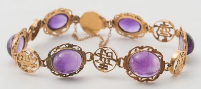 An amethyst and '14K' stamped bracelet: with oval cabochon amethysts between circular panels with