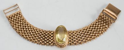 A 9ct gold bracelet with central-set, oval citrine:, 31gms gross weight.