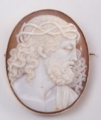 A gold framed, oval shell cameo brooch depicting Christ:, approximately 47mm long.