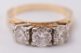 A graduated diamond three stone ring: with circular,