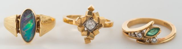 An 18ct gold and opal triplet mounted single-stone ring an emerald and diamond cluster ring and a
