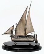 A Dutch silver model of a two-masted sailing boat: with sails, oars and tiller,