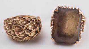 A 'feather' design dress ring stamped '18K', and a smoky quartz rectangular dress ring:.