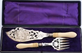 A pair of late Victorian plated fish servers: with pierced and decorated blade and tines,