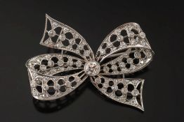 A mid 20th century platinum and diamond ribbon bow brooch: of pierced double loop and tails design,