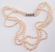 A graduated cultured pearl three string necklace:, the rectangular clasp with circular,