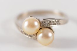 A white metal, cultured pearl and diamond cross-over ring:,