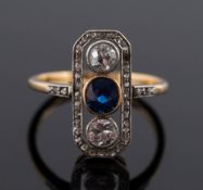 An early 20th century sapphire and diamond 'along the finger' three-stone ring: with central oval