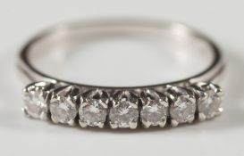 An 18ct white gold and diamond seven stone ring: with circular,